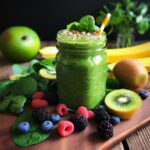 a vibrant green smoothie or juice packed with nutrient-rich leafy greens, luscious fruits, and an array of superfood toppings - a refreshing homage to the power of plant-based green beverages