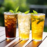 A close-up shot comparing different iced tea varieties. The glasses contain green tea, white tea, and herbal tea - each displaying their distinct colors and characteristics. Explore the health benefits of these alternative iced tea options!